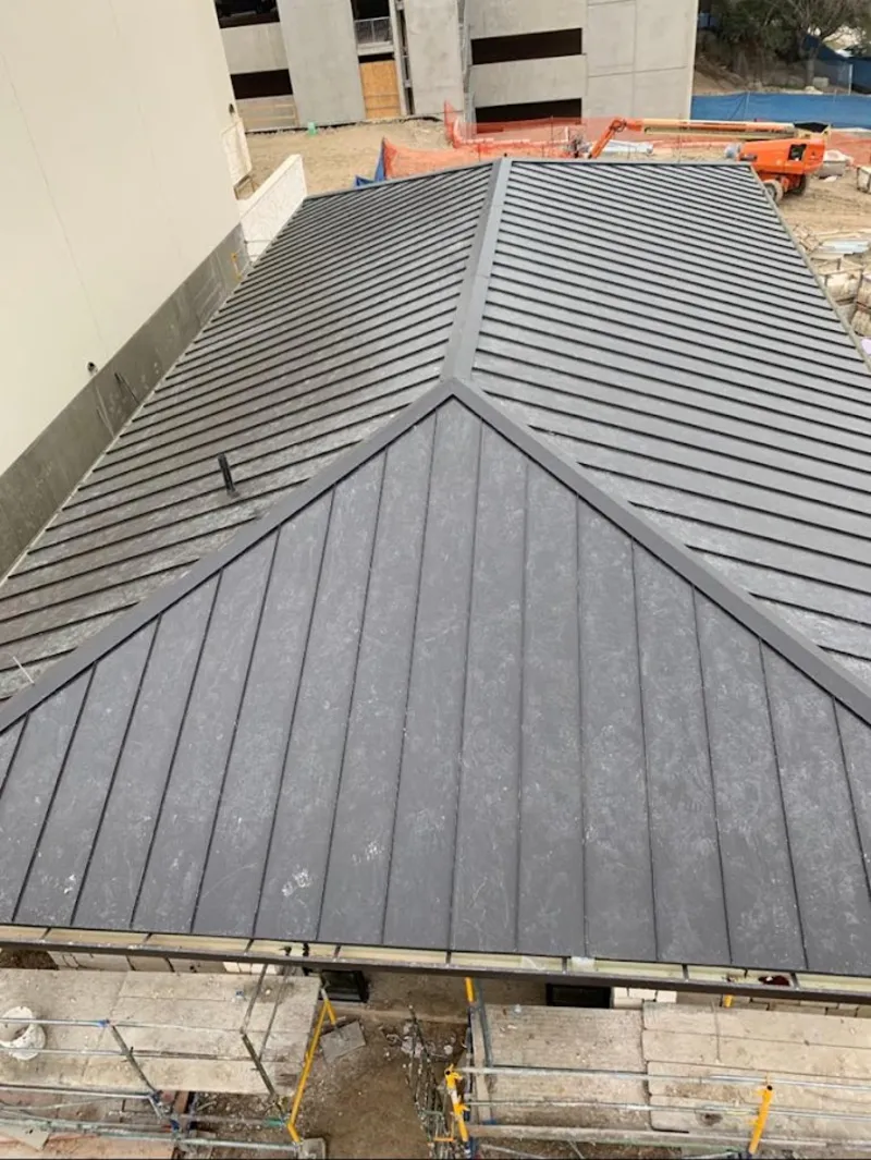 Commercial metal roof construction with crane equipment in Bourbonnais