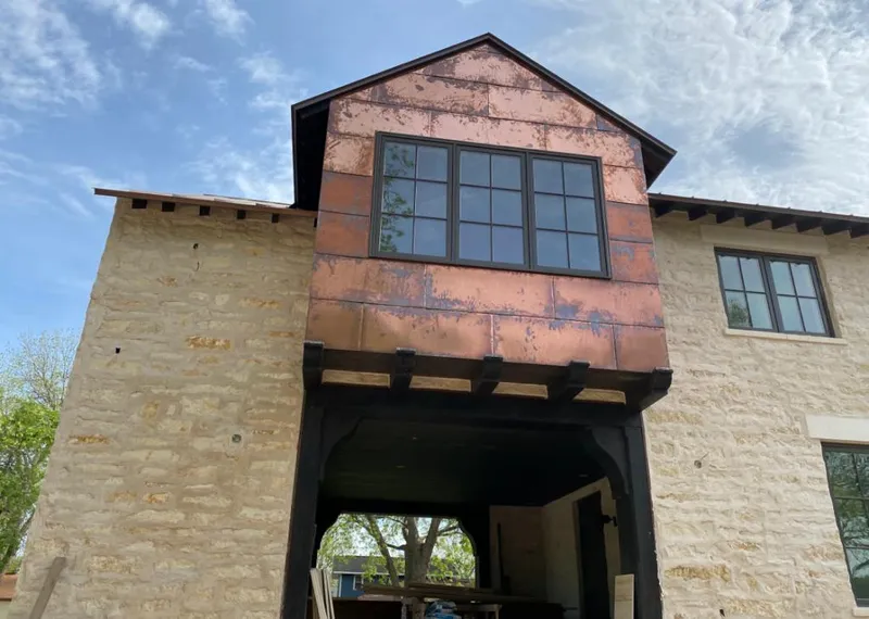 Copper metal panel facade on a stone building for Skylight Installation in Bourbonnais